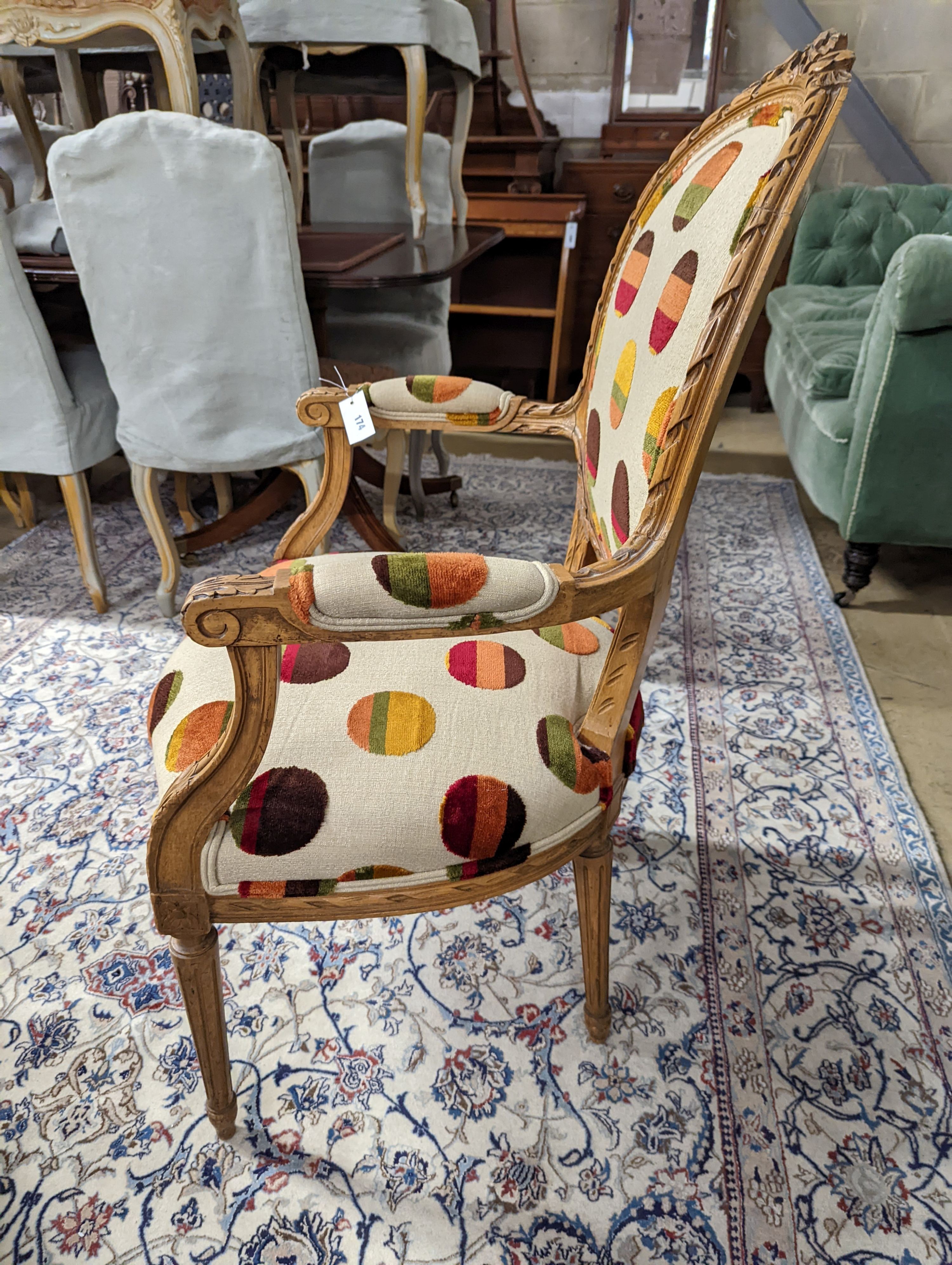 A Louis XVI style carved beech upholstered open armchair, width 62cm, depth 62cm, height 102cm